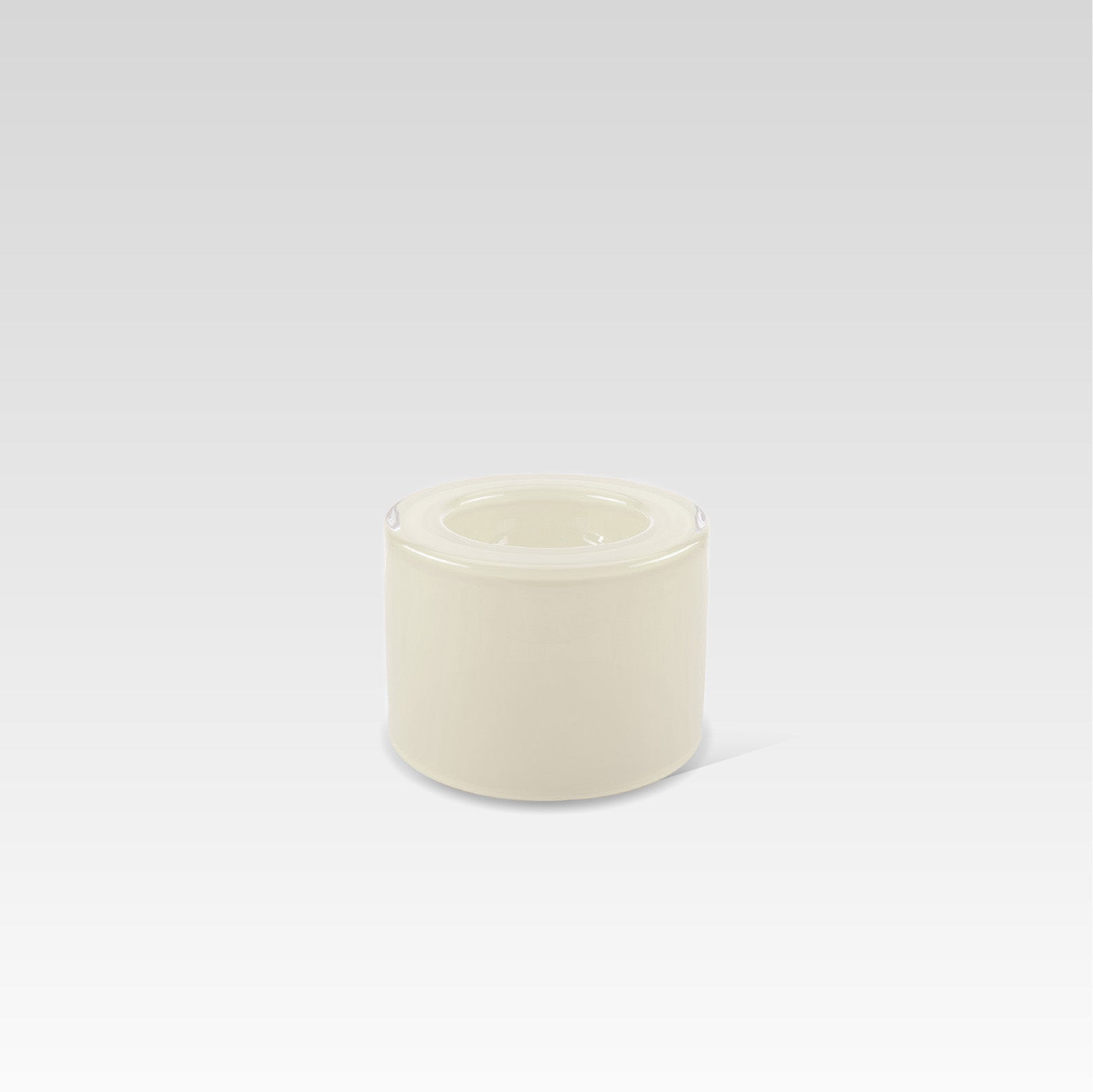 A high vanilla-colored handmade glass bowl on a plain background, designed to create surface tension optical illusion when filled