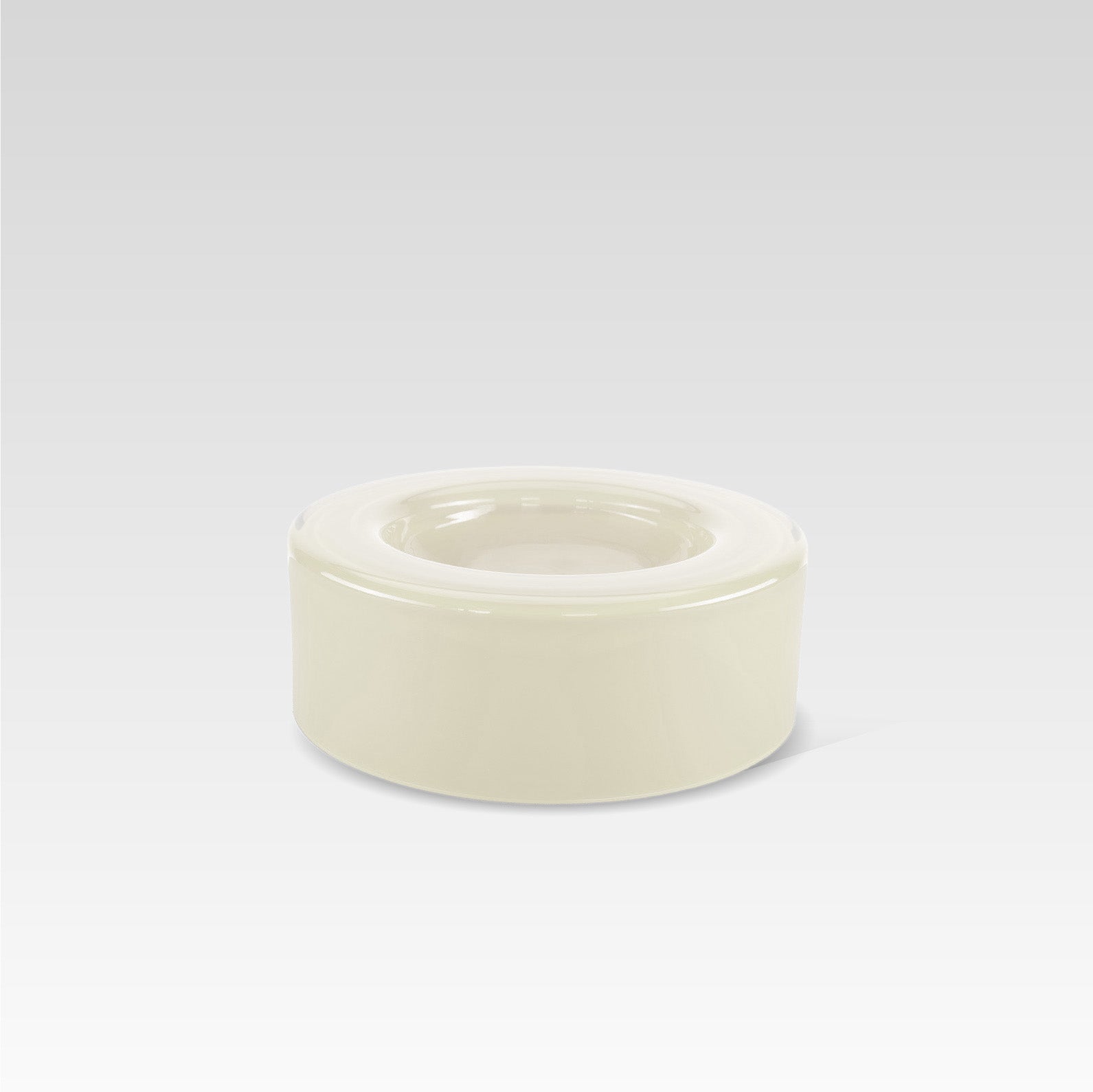 A medium-sized, handmade vanilla white glass bowl with a curved shape, displayed against a neutral background