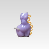 Purple glass womans figure with an apricot coloured spiral on the right side and a white shape on the left waist, positioned on a white background
