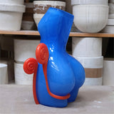 Blue and red abstract sculpture in a pottery studio