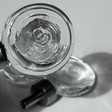 Close up of the flux knob, with beautiful light and another flux knob visible in the background laying on a white surface and light shining through it.