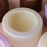 Wet bowl vanilla placed at the centre of several other coloured bowls. 