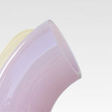 Close-up of the soft-pink nessie carafe, on a light gray background.