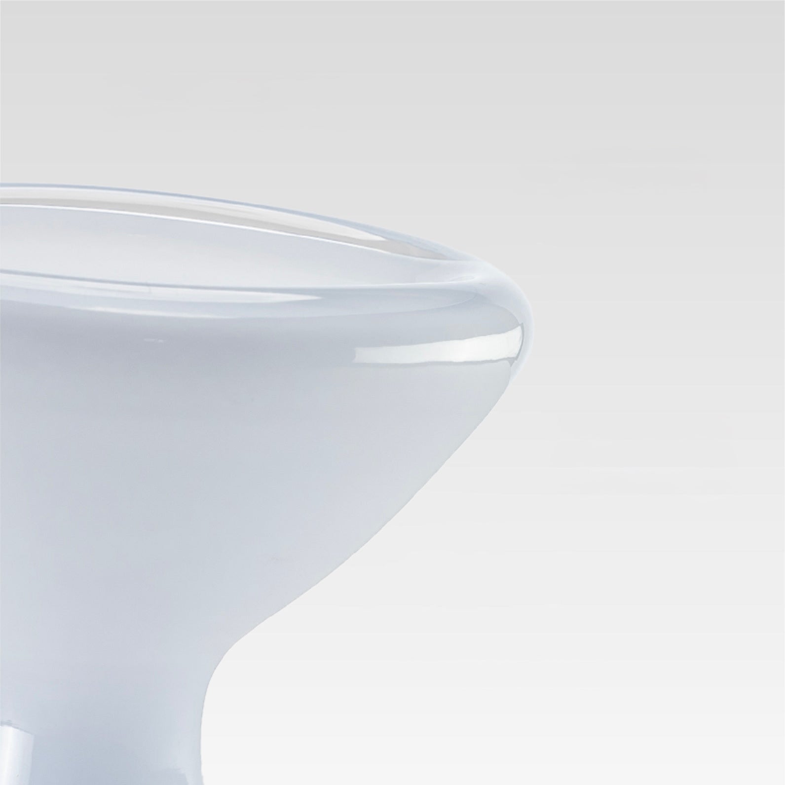 Close-up of a white surface with a clear glass object on top