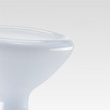 Close-up of a white surface with a clear glass object on top