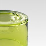 Close-up of the high translucent lime green wet bowl showing the thick rim and smooth curved surface against a light gray background.