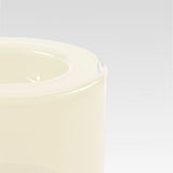 Close-up of the corner of a smooth vanilla white bowl on a light gray background
