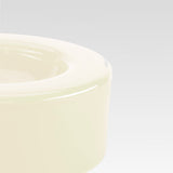 The corner of the smooth vanilla bowl is visible in this closeup, on a light gray background