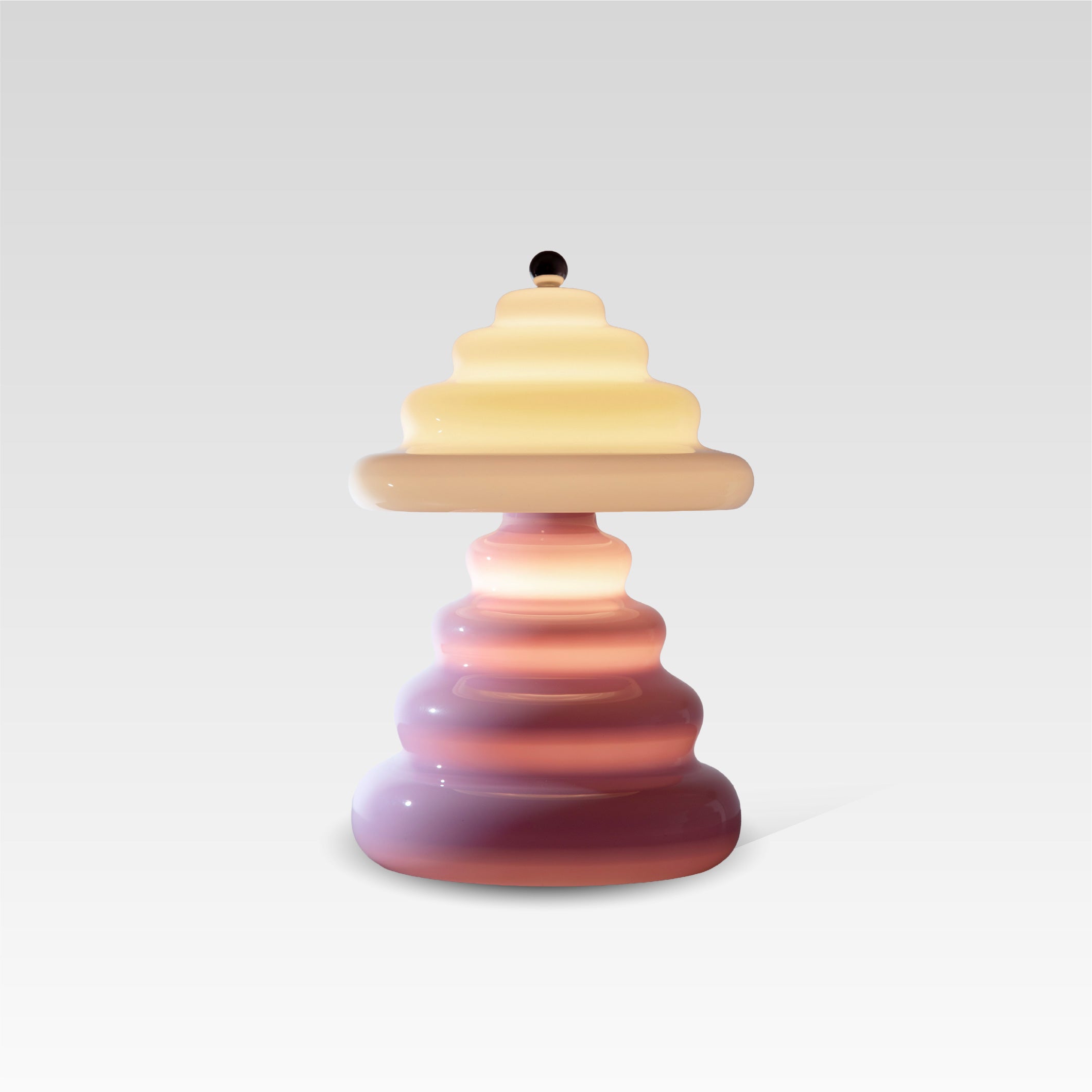 Pulsar lamp transitioning from a soft pink on the bottom to a vanilla on the top