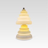 Pulsar lamp with a layered, wavy design on a light gray background.