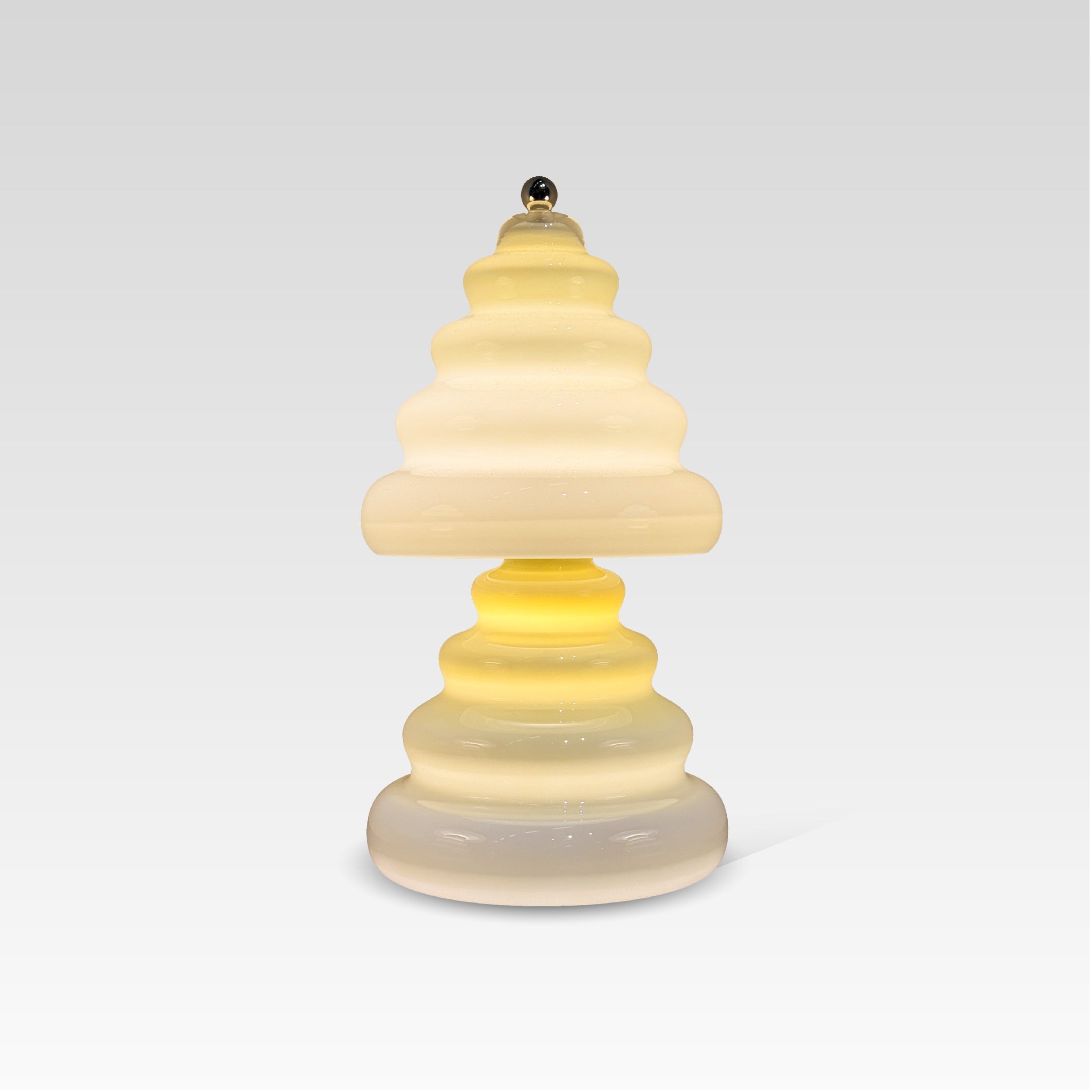 Pulsar lamp with a layered, wavy design on a light gray background
