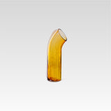 Curved amber coloured glass vase with a pale apricot strip of glass on the back of it, positioned on a white background