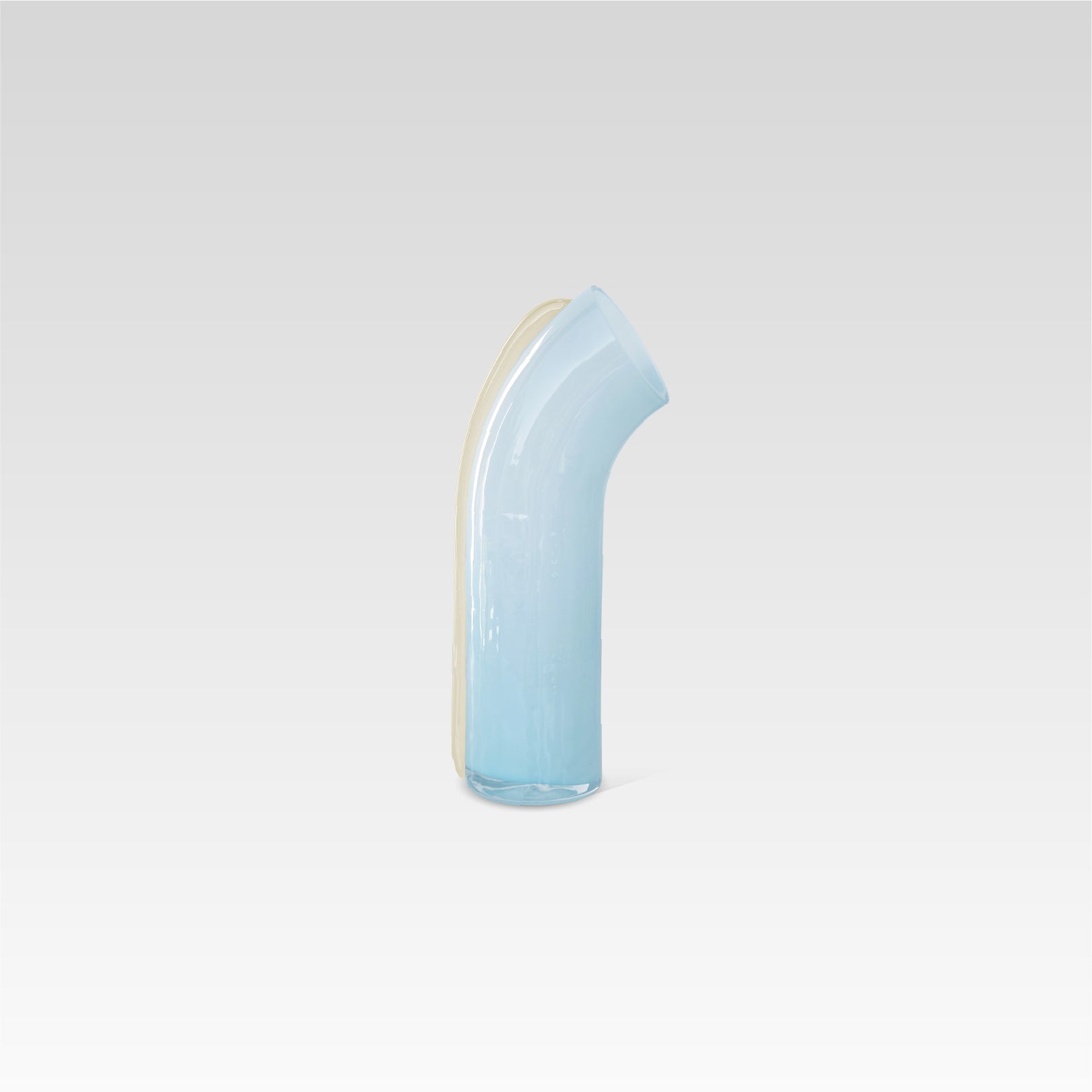 Soft blue nessie with a vanilla stripe on the back, curved object, on a light gray background