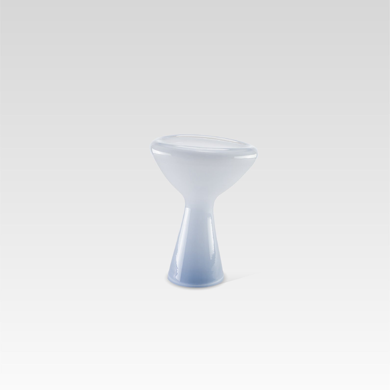 A unique, soft blue glass serving dish with an irregular shape, designed for serving snacks or desserts or as a decorative centerpiece