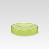 Handmade green glass bowl with a smooth surface and a subtle shine, designed to make objects appear to float on its surface.