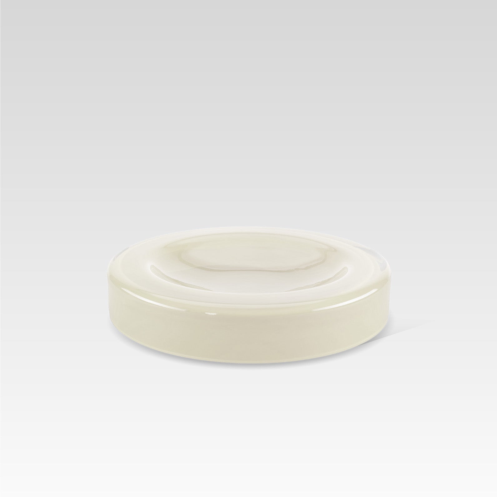 A handmade vanilla white glass bowl with a smooth surface and rounded edges, displayed against a neutral background