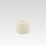 A high vanilla-colored handmade glass bowl on a plain background, designed to create surface tension optical illusion when filled.