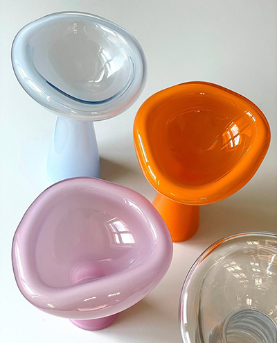 Four colorful glass phantom dishes on a white table