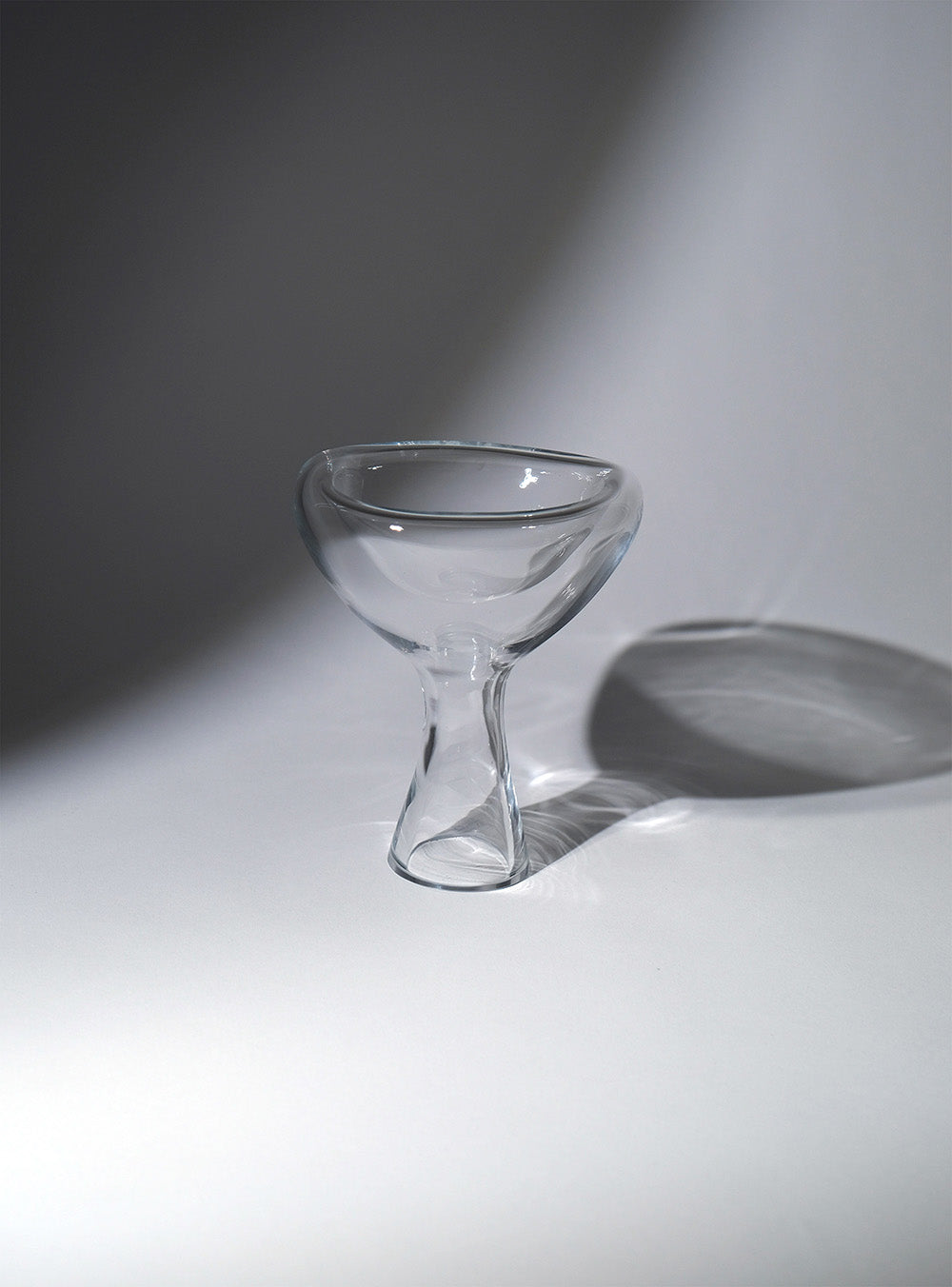 Crystal transparent phantom dish with a shadow in the background and soft lighting