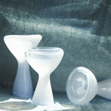 Three soft blue phantom dishes on a textured blue surface.