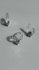 Three Flux Cabinet Knobs standing on top of their metal fittings with sunlight shining through them. The camera moves between the knobs to reveal different angles and natural lighting.