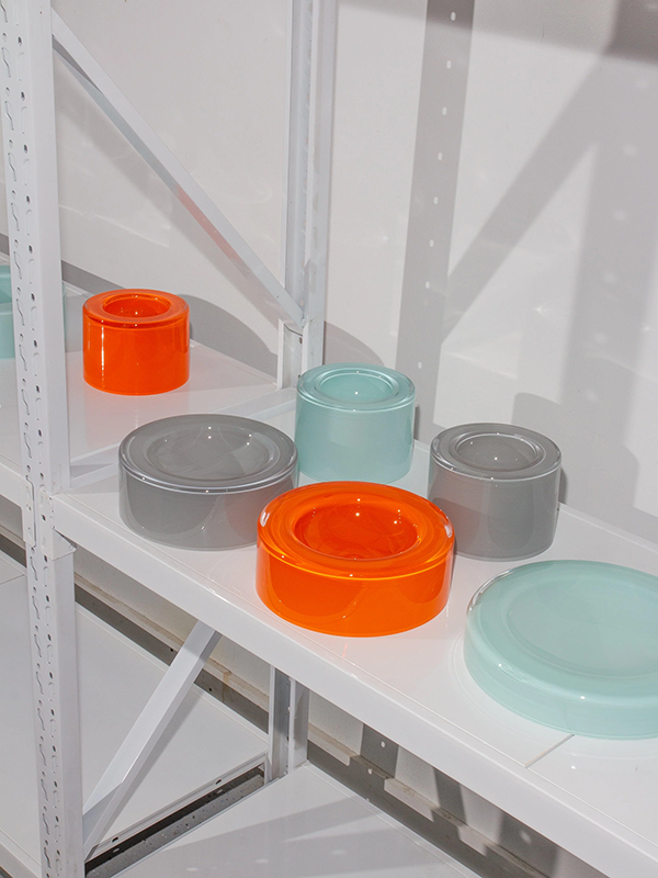 Colorful glass wetbowls on a metal shelf